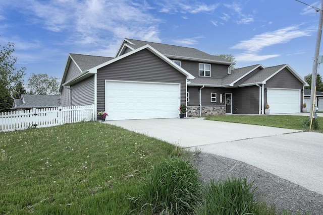 N406 Marion Ave, Appleton, WI 54915 - view of front of property featuring a garage, driveway, stone siding, and roof with shingles