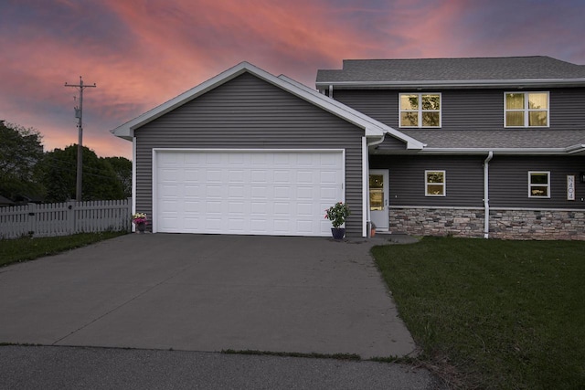 N406 Marion Ave, Appleton, WI 54915 - view of front of house featuring concrete driveway, a garage, stone siding, and roof with shingles