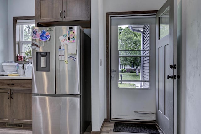 N406 Marion Ave, Appleton, WI 54915 - kitchen with stainless steel refrigerator with ice dispenser, healthy amount of natural light, light wood-style flooring, and light countertops