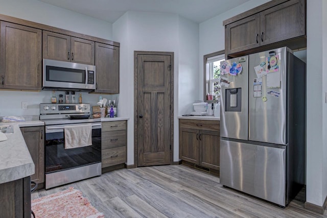 N406 Marion Ave, Appleton, WI 54915 - kitchen featuring stainless steel appliances, light countertops, dark brown cabinetry, and light wood finished floors