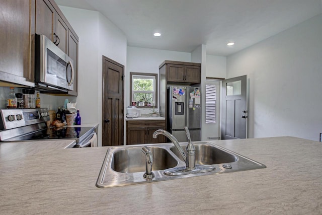 N406 Marion Ave, Appleton, WI 54915 - kitchen featuring stainless steel appliances, a sink, dark brown cabinetry, light countertops, and recessed lighting