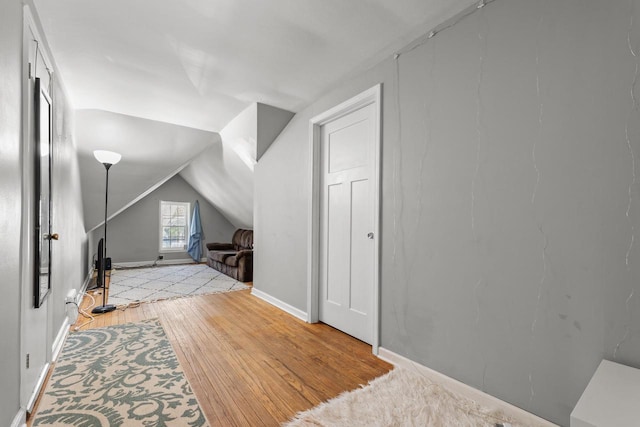 4131 N 41st St, Milwaukee, WI 53216 - additional living space featuring vaulted ceiling, light wood finished floors, and baseboards