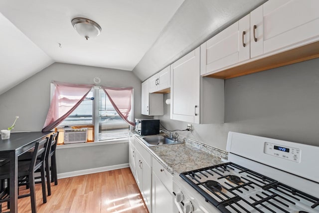 4131 N 41st St, Milwaukee, WI 53216 - kitchen featuring white gas stove, a sink, black microwave, light wood-style flooring, and cooling unit
