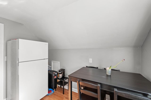 4131 N 41st St, Milwaukee, WI 53216 - kitchen with freestanding refrigerator, lofted ceiling, and light wood-style flooring