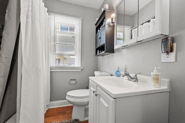 4131 N 41st St, Milwaukee, WI 53216 - bathroom featuring vanity, toilet, wood finished floors, baseboards, and a shower with shower curtain