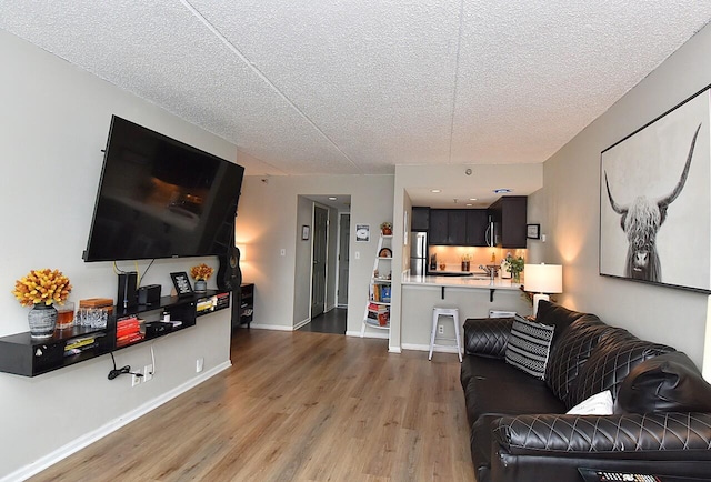 270 E Highland Ave Unit 644, Milwaukee, WI 53202 - living area with wood finished floors, a textured ceiling, and baseboards