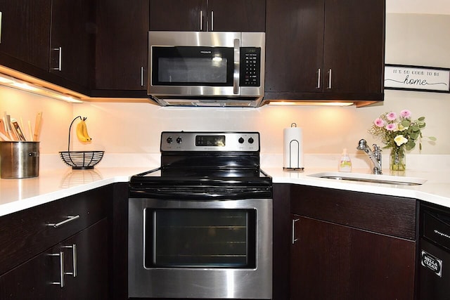 270 E Highland Ave Unit 644, Milwaukee, WI 53202 - kitchen with appliances with stainless steel finishes, a sink, light countertops, and dark brown cabinets