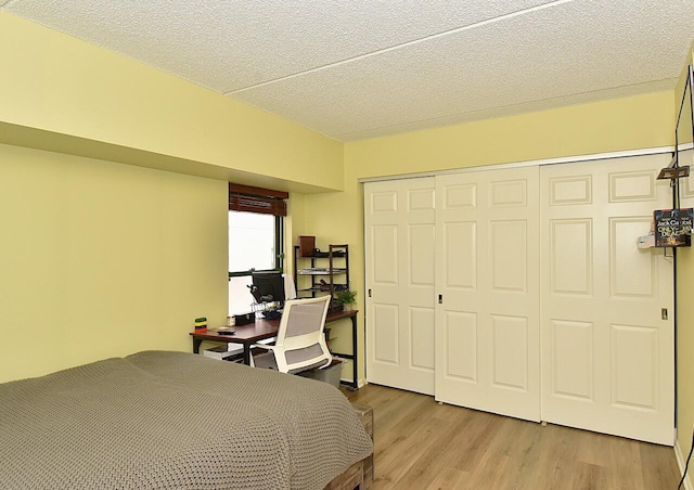 270 E Highland Ave Unit 644, Milwaukee, WI 53202 - bedroom featuring light wood finished floors, a closet, and a textured ceiling