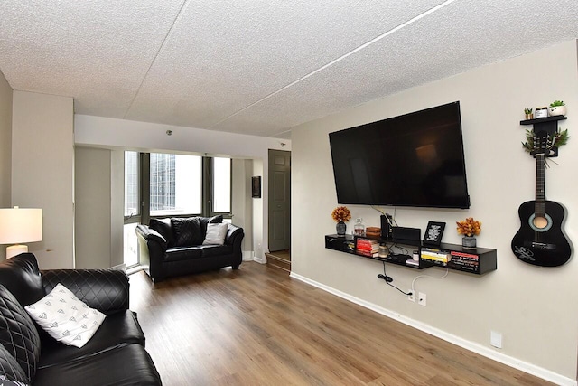270 E Highland Ave Unit 644, Milwaukee, WI 53202 - living room featuring wood finished floors, a textured ceiling, and baseboards