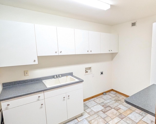 N8292 Deadwood Point Rd, Fond Du Lac, WI 54937 - laundry room with electric dryer hookup, hookup for a washing machine, baseboards, cabinet space, and stone finish floors