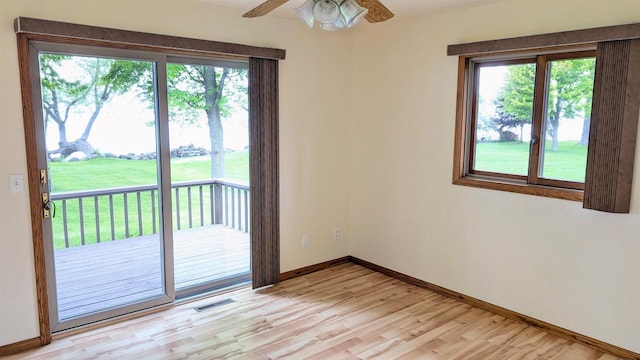 N8292 Deadwood Point Rd, Fond Du Lac, WI 54937 - empty room with healthy amount of natural light, light wood-style floors, baseboards, and a ceiling fan