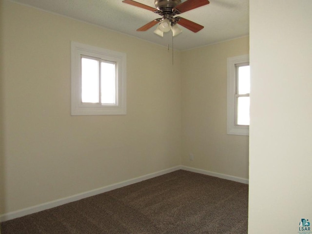701 N 22nd St, Superior, WI 54880 - empty room with plenty of natural light, carpet flooring, ceiling fan, and baseboards