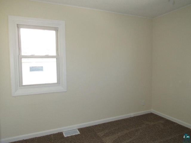 701 N 22nd St, Superior, WI 54880 - spare room featuring ornamental molding, baseboards, and dark colored carpet