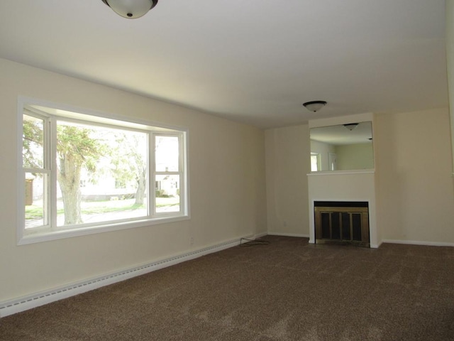 701 N 22nd St, Superior, WI 54880 - unfurnished living room with a baseboard radiator, plenty of natural light, and carpet