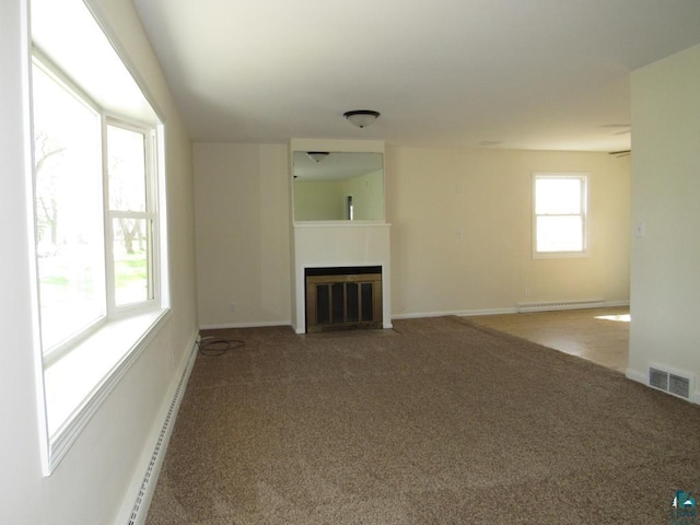 701 N 22nd St, Superior, WI 54880 - unfurnished living room featuring carpet, a fireplace with flush hearth, and baseboards