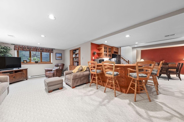 1420 Hidden Fields Dr, West Bend, WI 53095 - carpeted living room with a baseboard heating unit, recessed lighting, a dry bar, stairway, and baseboards