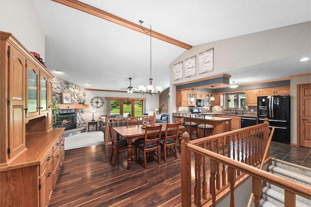 1420 Hidden Fields Dr, West Bend, WI 53095 - dining space featuring a ceiling fan, a fireplace, and dark wood-style floors