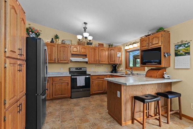 557 Center St, Berlin, WI 54923 - kitchen featuring appliances with stainless steel finishes, under cabinet range hood, a peninsula, a kitchen breakfast bar, and lofted ceiling