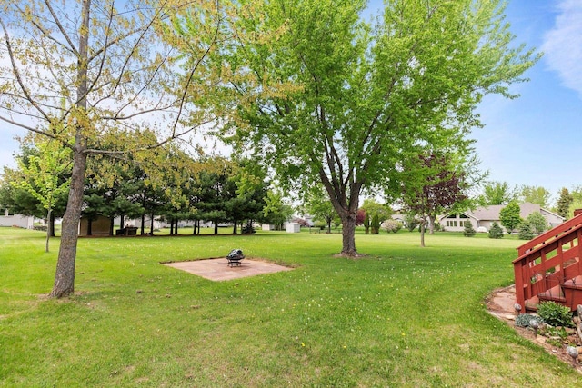 557 Center St, Berlin, WI 54923 - view of grassy yard featuring a fire pit and a patio area