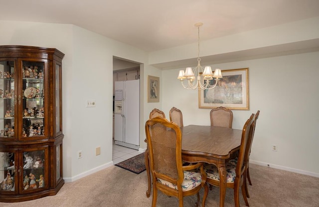 8707 Westlake Dr, Greendale, WI 53129 - dining space with a chandelier, light colored carpet, and baseboards