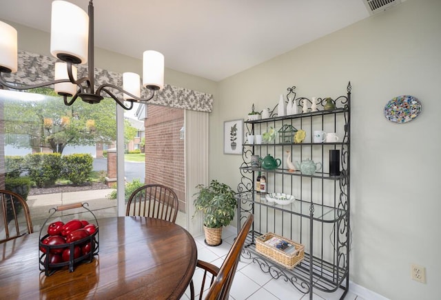 8707 Westlake Dr, Greendale, WI 53129 - dining room featuring a chandelier, tile patterned flooring, and baseboards