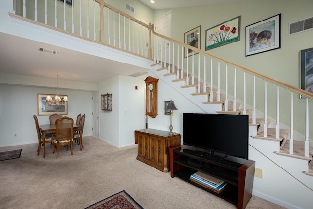 8707 Westlake Dr, Greendale, WI 53129 - living room with stairway, a towering ceiling, carpet flooring, a chandelier, and recessed lighting