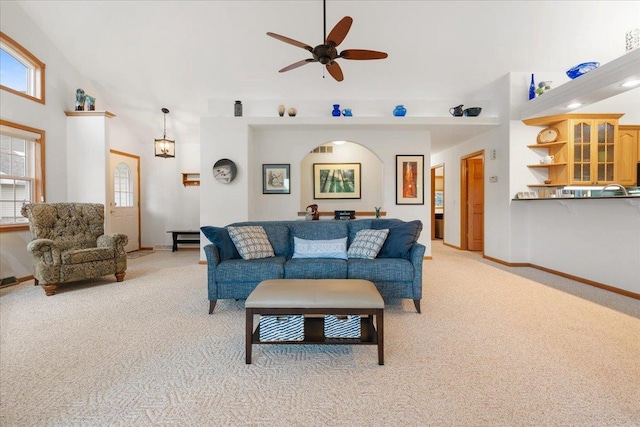 119 Summit Ct, Columbus, WI 53925 - living room with light carpet, a towering ceiling, ceiling fan, and baseboards