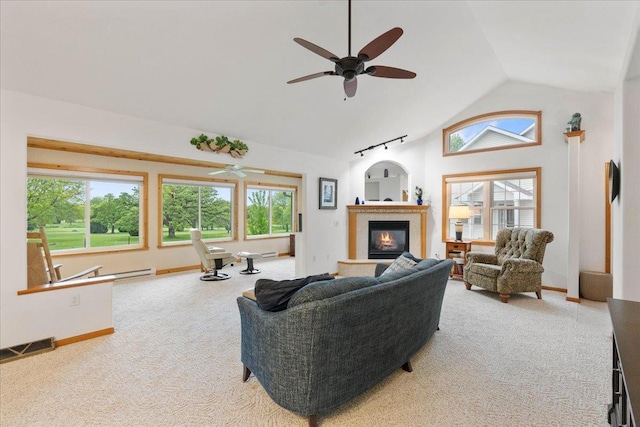 119 Summit Ct, Columbus, WI 53925 - living room featuring lofted ceiling, plenty of natural light, carpet floors, baseboards, and a glass covered fireplace