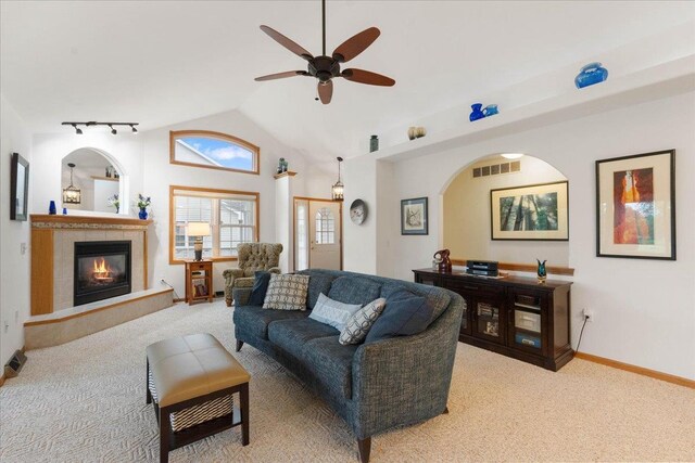 119 Summit Ct, Columbus, WI 53925 - living area with carpet, ceiling fan, vaulted ceiling, rail lighting, and a fireplace