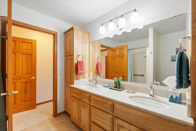 119 Summit Ct, Columbus, WI 53925 - full bath featuring double vanity, tile patterned flooring, a shower, and baseboards