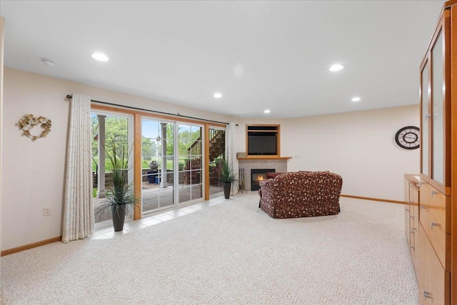 119 Summit Ct, Columbus, WI 53925 - living room featuring a glass covered fireplace, baseboards, recessed lighting, and light colored carpet