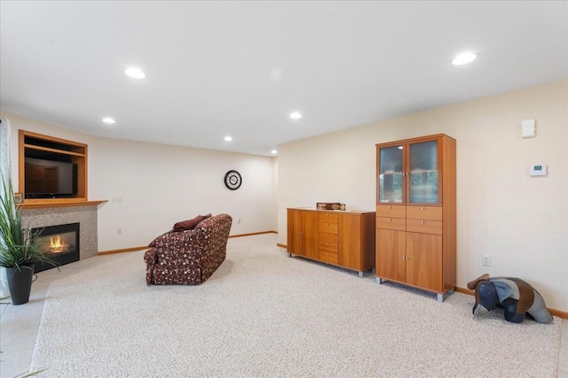 119 Summit Ct, Columbus, WI 53925 - living area with light colored carpet, recessed lighting, a glass covered fireplace, and baseboards