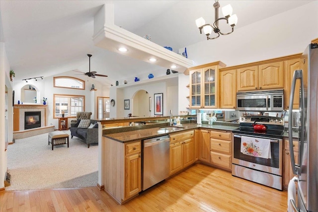 119 Summit Ct, Columbus, WI 53925 - kitchen with appliances with stainless steel finishes, a sink, a peninsula, a ceiling fan, and glass insert cabinets