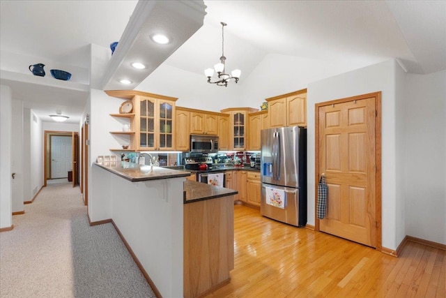 119 Summit Ct, Columbus, WI 53925 - kitchen with appliances with stainless steel finishes, a peninsula, dark countertops, a chandelier, and hanging light fixtures