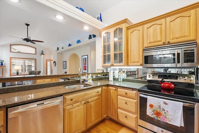 119 Summit Ct, Columbus, WI 53925 - kitchen with stainless steel appliances, a sink, dark stone counters, ceiling fan, and lofted ceiling