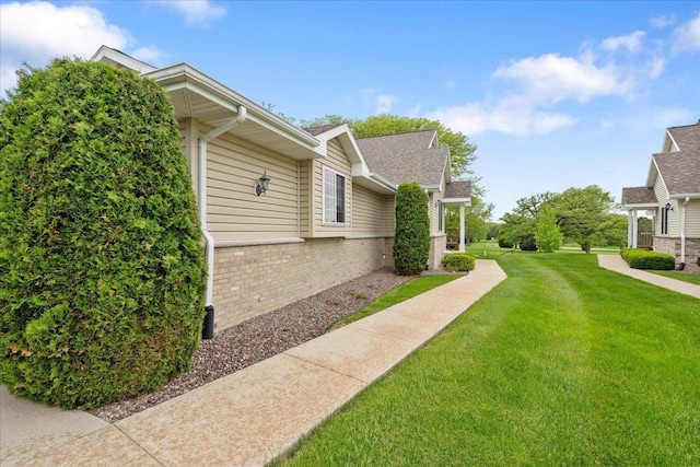 119 Summit Ct, Columbus, WI 53925 - view of side of home featuring brick siding and a yard