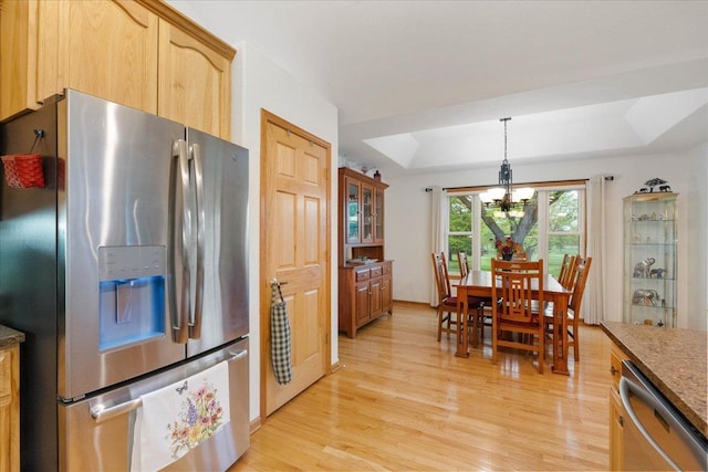 119 Summit Ct, Columbus, WI 53925 - kitchen with appliances with stainless steel finishes, a raised ceiling, light wood-type flooring, a chandelier, and pendant lighting