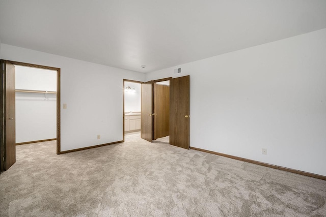 7233 W Wabash Ave, Milwaukee, WI 53223 - unfurnished bedroom with carpet, baseboards, a spacious closet, a closet, and ensuite bathroom