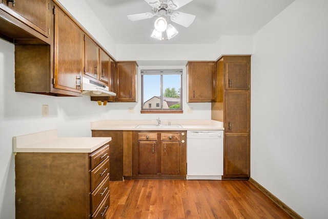 7233 W Wabash Ave, Milwaukee, WI 53223 - kitchen featuring white dishwasher, a sink, under cabinet range hood, a ceiling fan, and wood finished floors