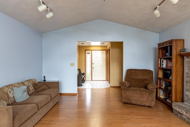 1074 Pendleton Rd, Neenah, WI 54956 - living room with track lighting, light wood-type flooring, lofted ceiling, and baseboards