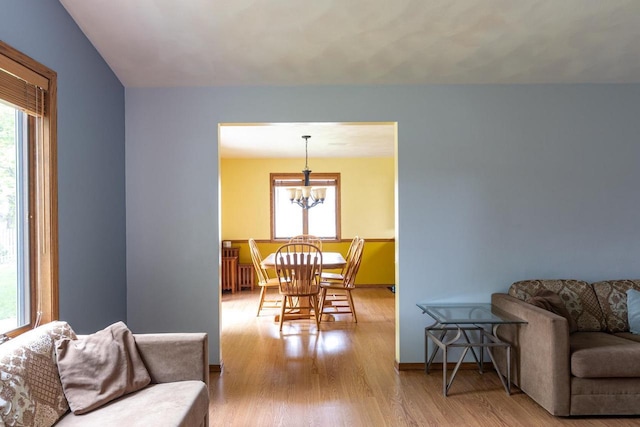 1074 Pendleton Rd, Neenah, WI 54956 - living room featuring healthy amount of natural light, a chandelier, wood finished floors, and baseboards