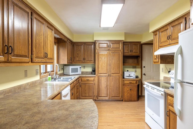 1074 Pendleton Rd, Neenah, WI 54956 - kitchen with white appliances, under cabinet range hood, and brown cabinets