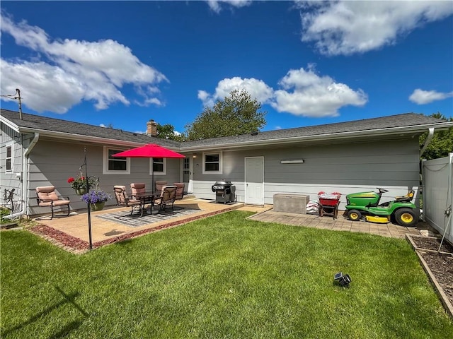 709 E Fillmore Ave, Eau Claire, WI 54701 - rear view of house with a patio area and a lawn