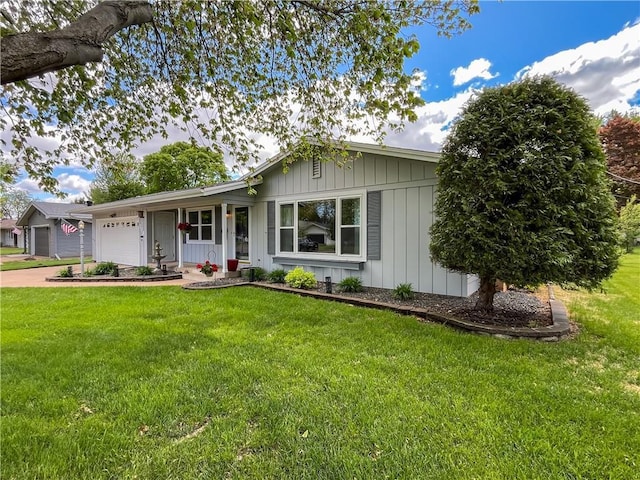 709 E Fillmore Ave, Eau Claire, WI 54701 - single story home with an attached garage, board and batten siding, a front lawn, and concrete driveway