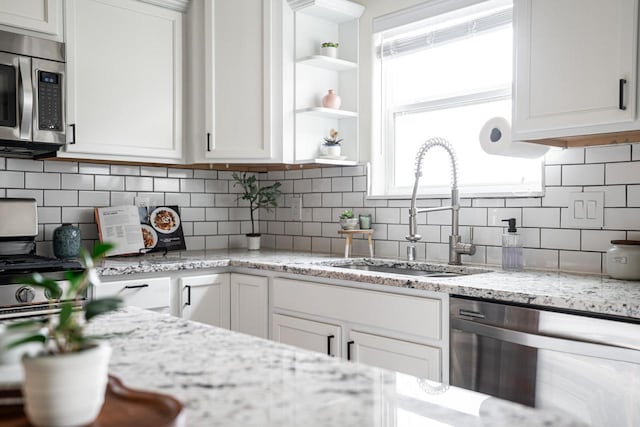 6544 Biscayne Ave, Mount Pleasant, WI 53406 - kitchen with stainless steel appliances, a sink, white cabinetry, backsplash, and open shelves