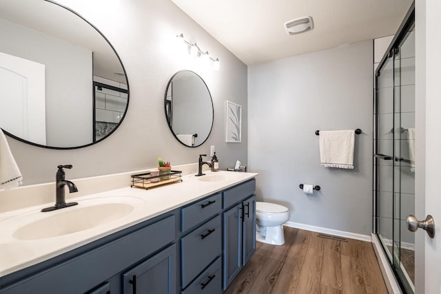 6544 Biscayne Ave, Mount Pleasant, WI 53406 - bathroom with toilet, double vanity, wood finished floors, an enclosed shower, and baseboards