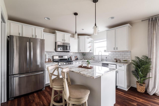 6544 Biscayne Ave, Mount Pleasant, WI 53406 - kitchen with stainless steel appliances, a sink, dark wood-style flooring, white cabinets, and recessed lighting