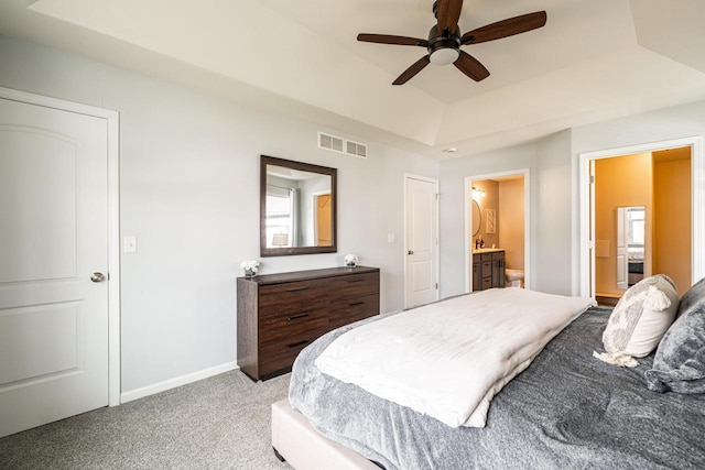 6544 Biscayne Ave, Mount Pleasant, WI 53406 - bedroom featuring a raised ceiling, light carpet, baseboards, ensuite bathroom, and a ceiling fan