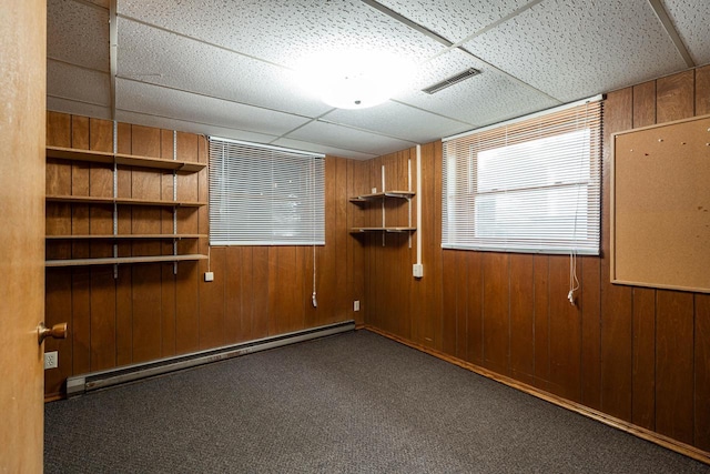 3324 96th St, Sturtevant, WI 53177 - carpeted spare room with a baseboard heating unit, wood walls, and a drop ceiling