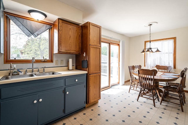 3324 96th St, Sturtevant, WI 53177 - kitchen featuring a sink, pendant lighting, light countertops, light floors, and brown cabinets